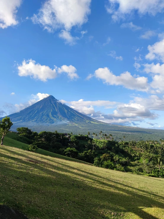 a large mountain covered in lots of clouds