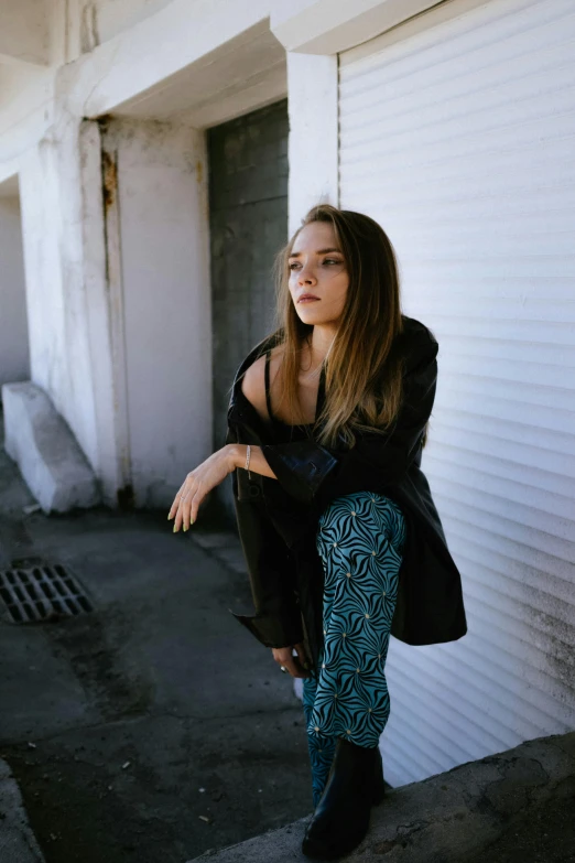 a woman posing on a ledge with her 