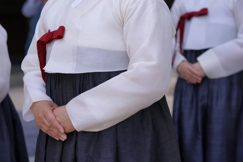 a group of people wearing uniforms and ties