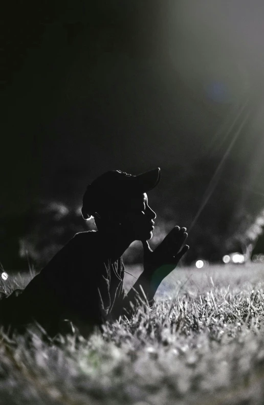 a person sitting in the grass on top of a skateboard