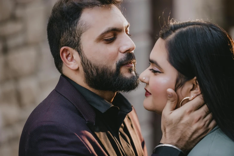 an image of a couple who are sharing a kiss