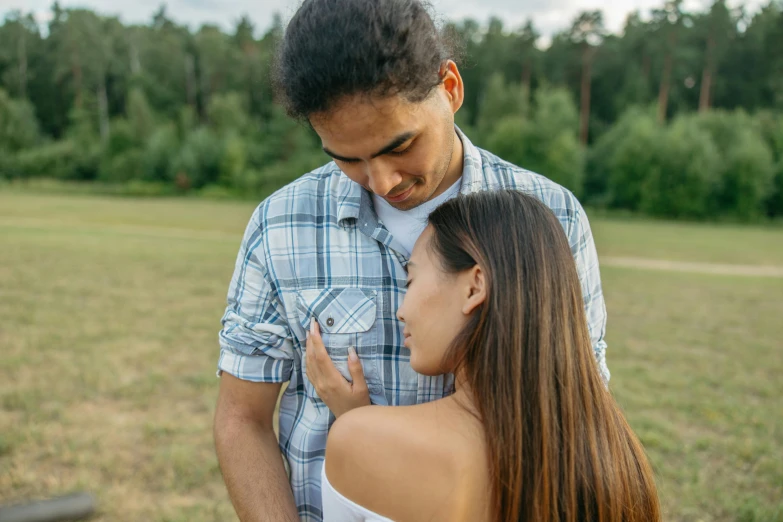 the man is posing with his wife next to him