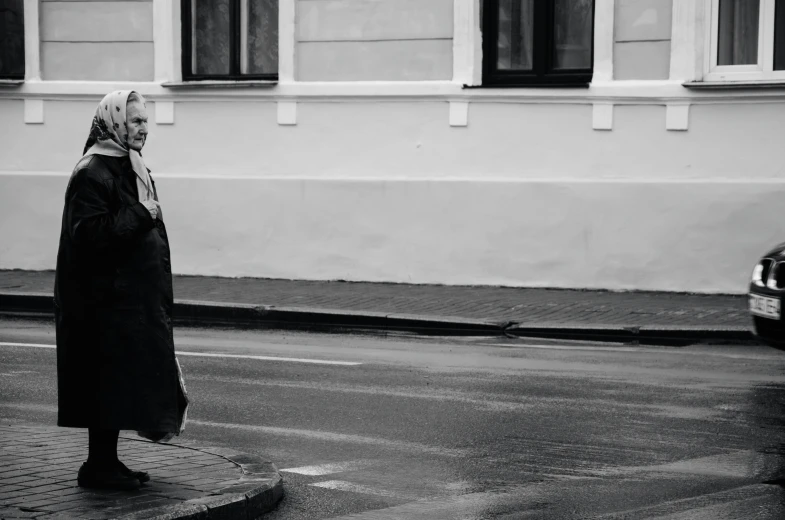 black and white pograph of a man walking on the street