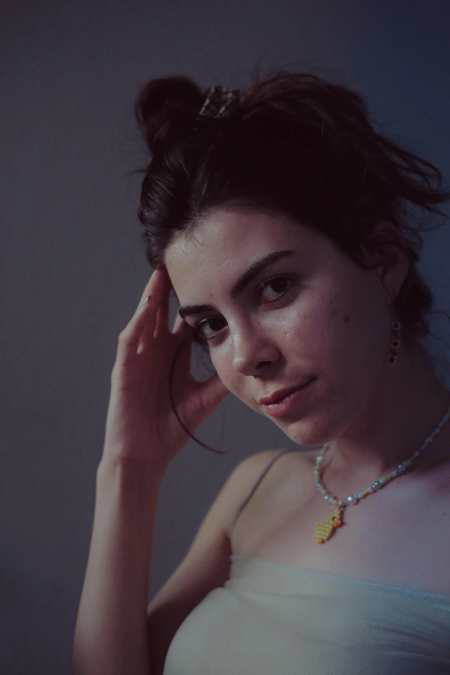 a young woman with a necklace is posing