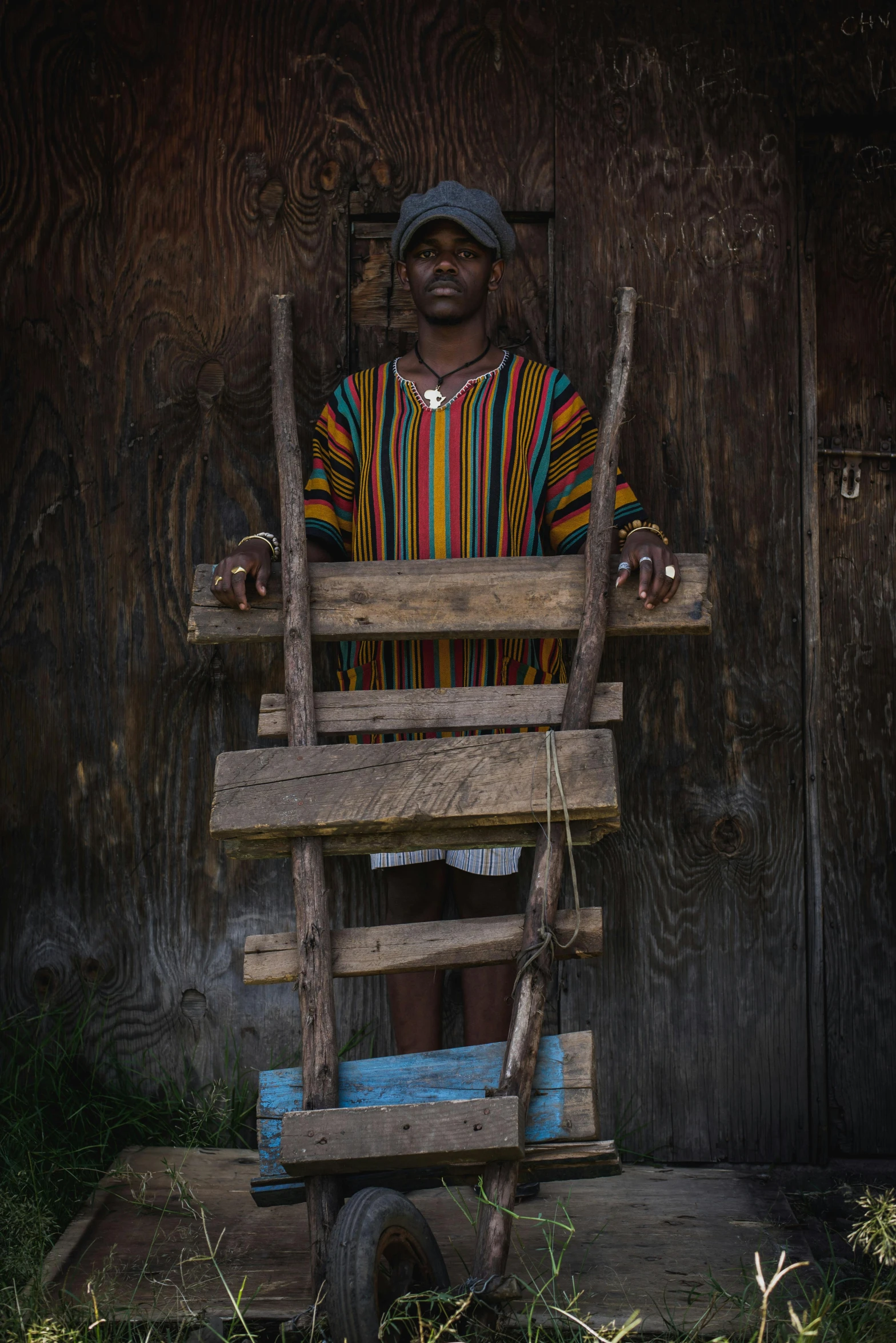 a man in colorful shirt sitting in the seat of a doll house