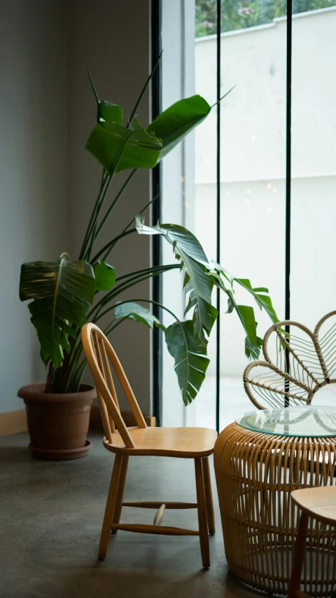 a glass table and chair in an open living room