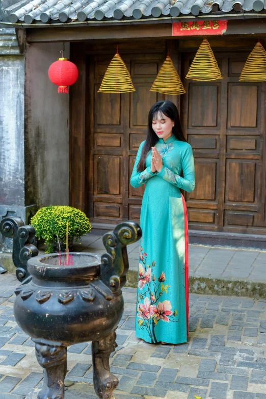 a woman standing in front of an oriental building