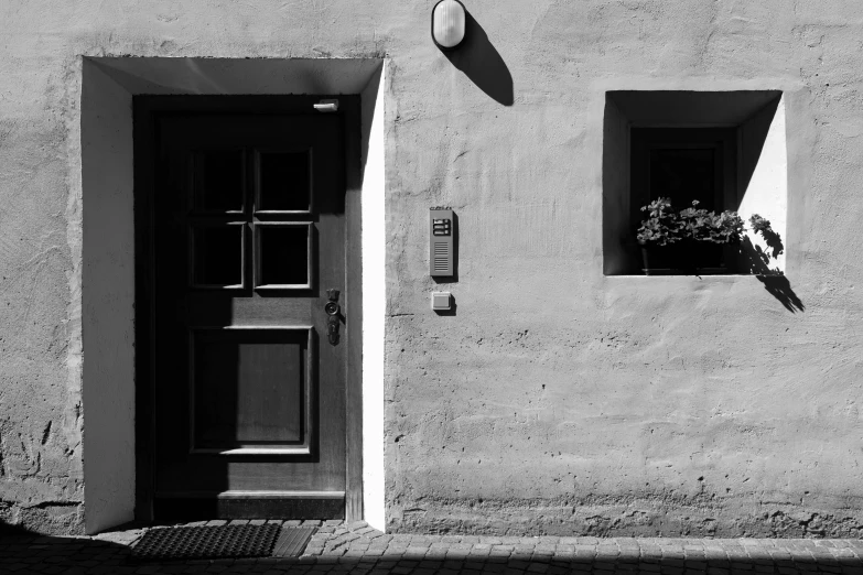 black and white po of a street light in front of a gray building