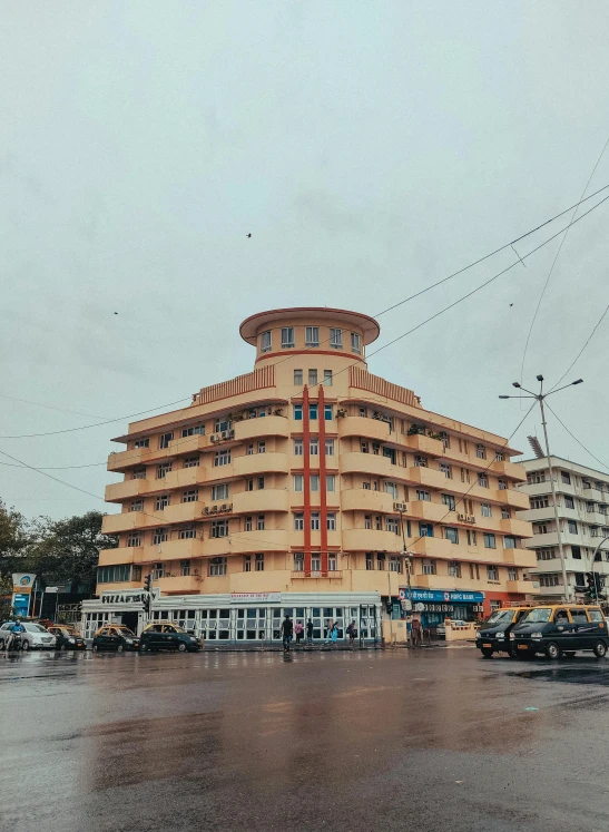 a very tall building with a lot of cars parked in front of it