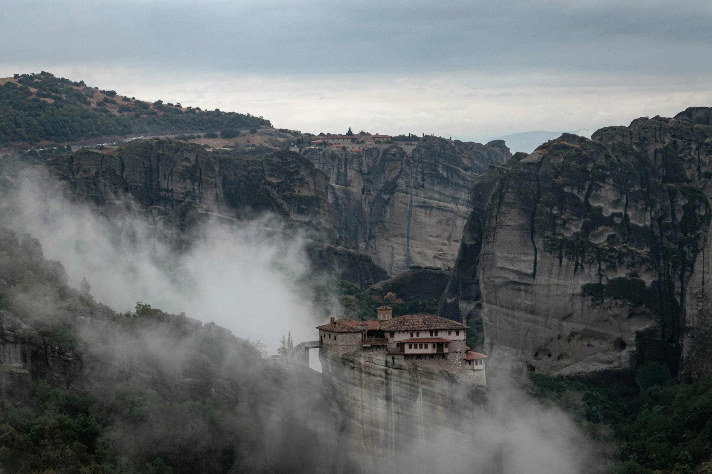 a mountain village sits on a cliff edge