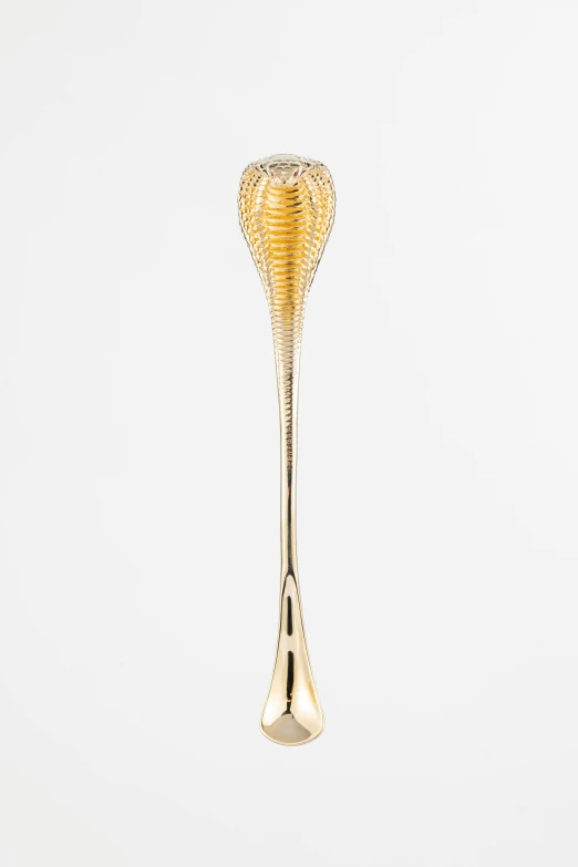 an ornate gold - plated glass goblet with the face of a co