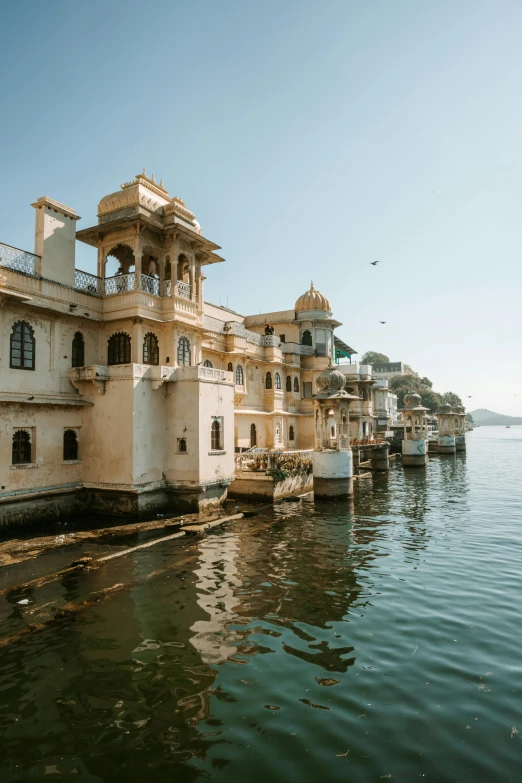 a couple of buildings sitting next to water