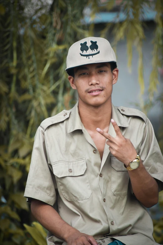 a man sitting with a wrist tattoo on his hand