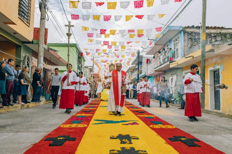 a man walking down a colorful path wearing red