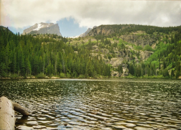 a small body of water with hills in the background