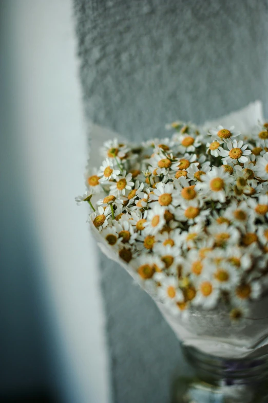 a vase with some daisies and other flowers