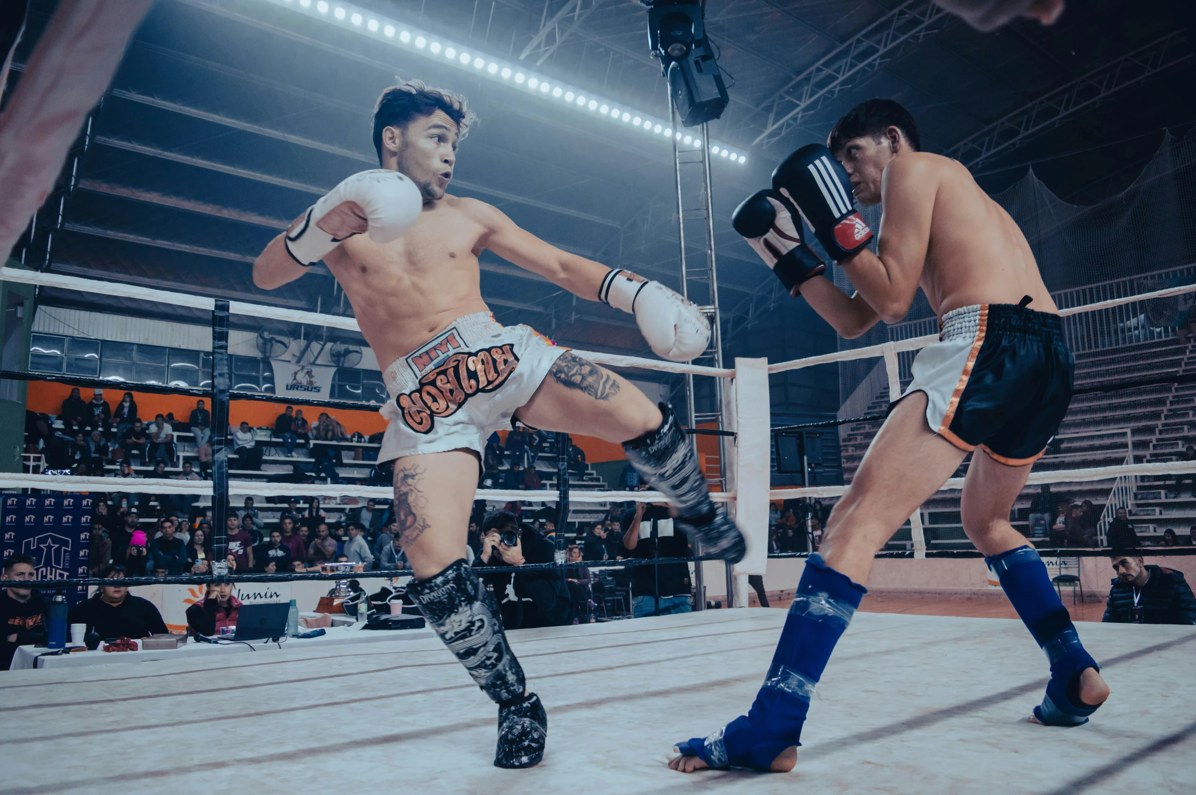 a wrestling match in the middle of a stadium with two wrestlers standing beside each other