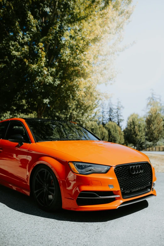 a orange sports car parked on the side of a road