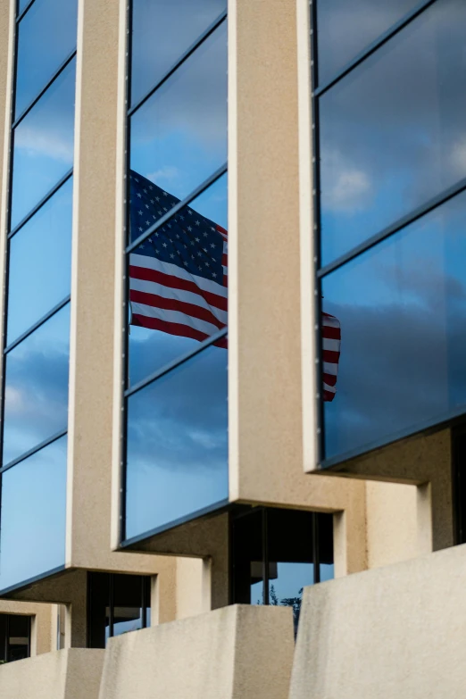 a large flag on the building next to some windows