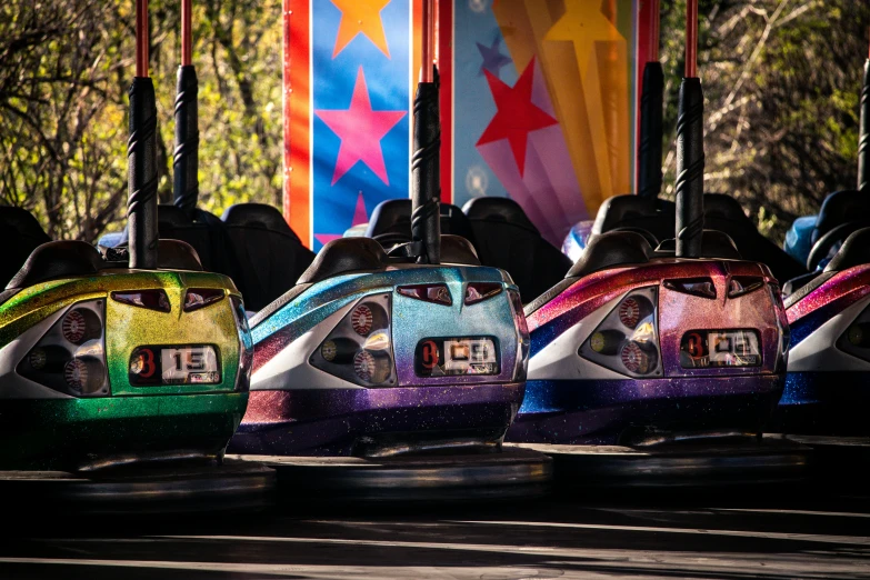 several colorful bumper cars on a ride at a carnival