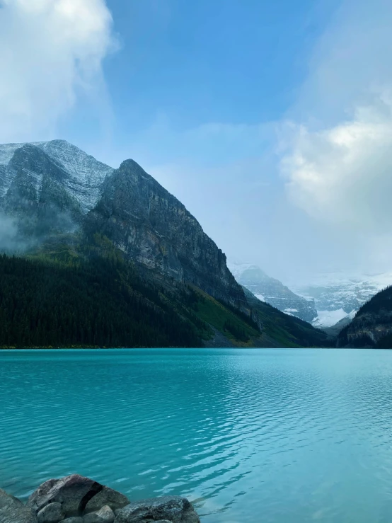 a picture with water and mountains in the background