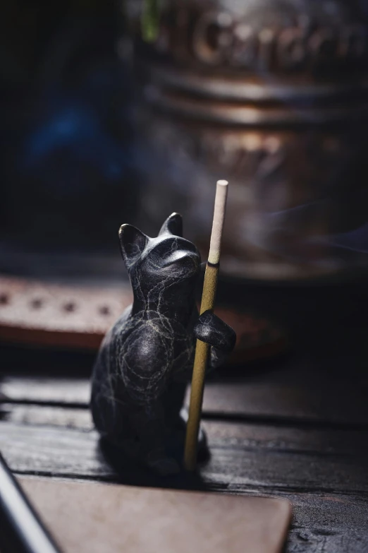 a figurine is holding a matchstick next to it