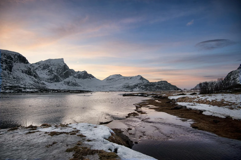 the sun is coming up over a mountain range