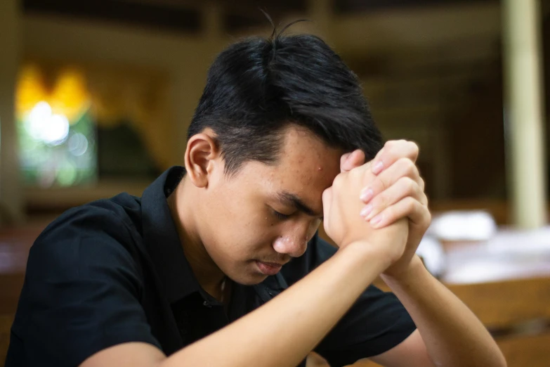 a man holding his head in his hands