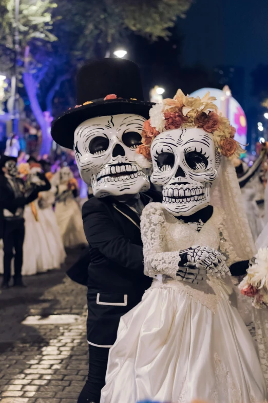 couple in black and white wedding attire and sugar skulls makeup
