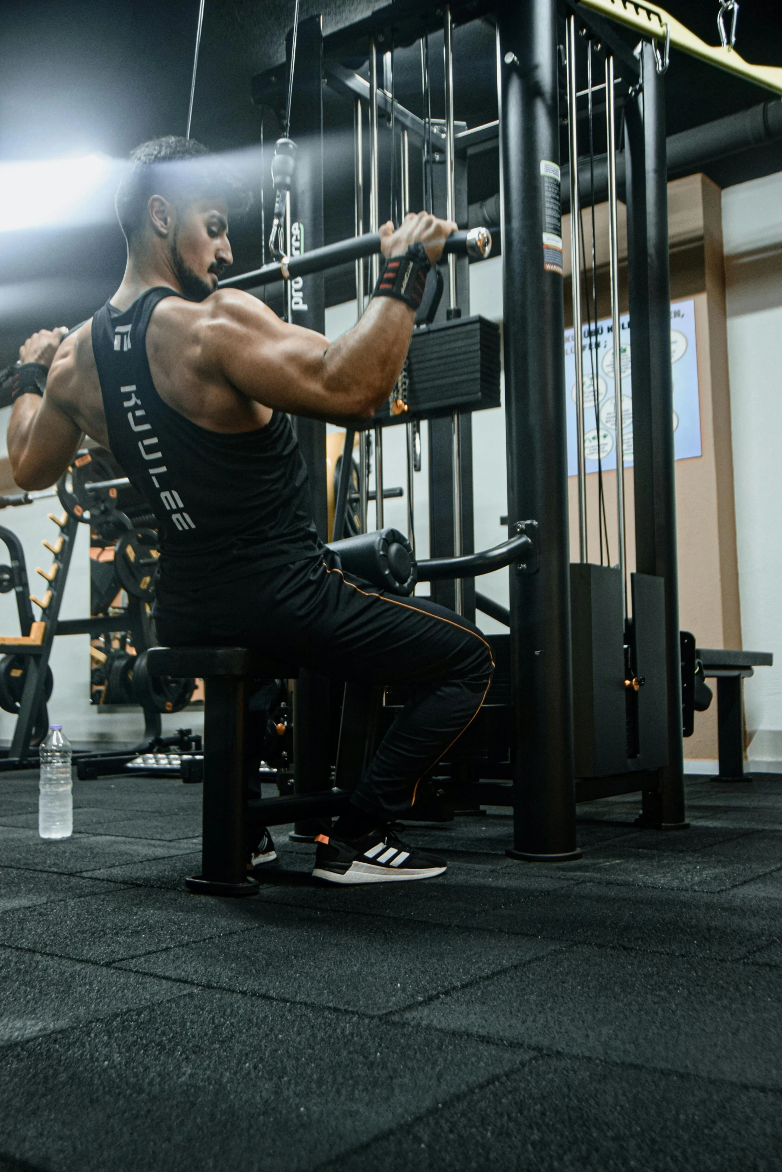 a man squatting down in front of a large machine