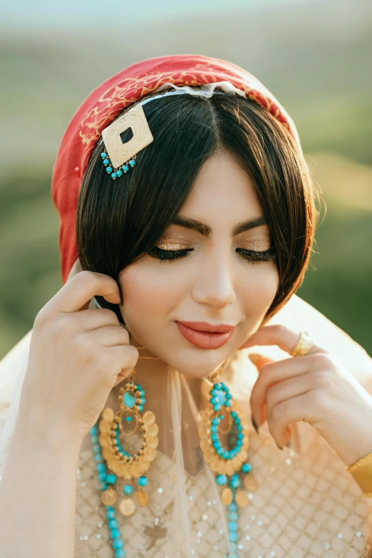 a beautiful woman wearing a traditional indian headdress and blue jewelry