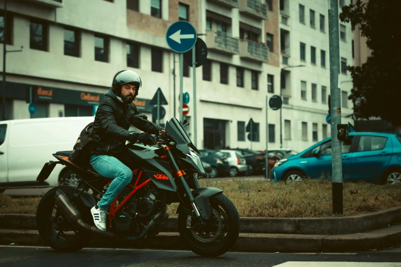 a man riding on the back of a black motorcycle