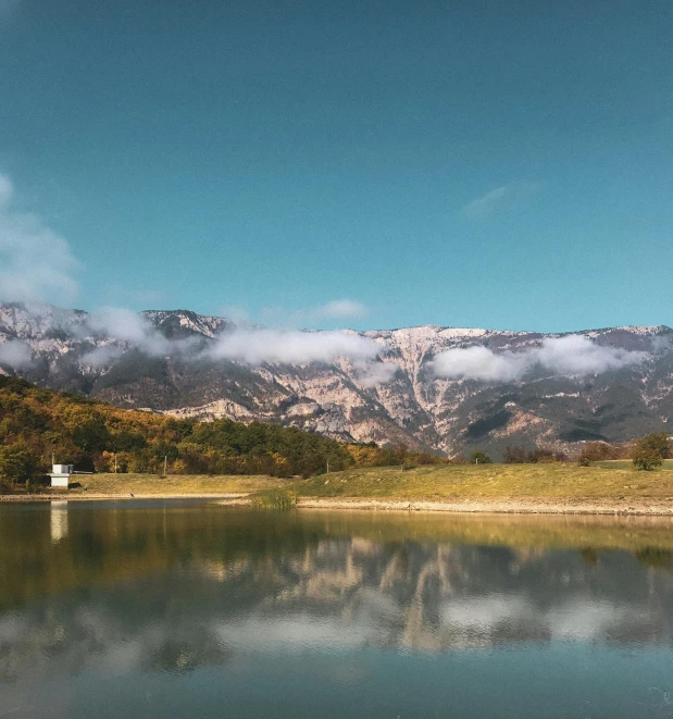 clouds float over the mountains in the valley