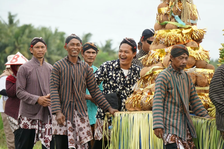 men are dressed up in costumes with a large group of other people