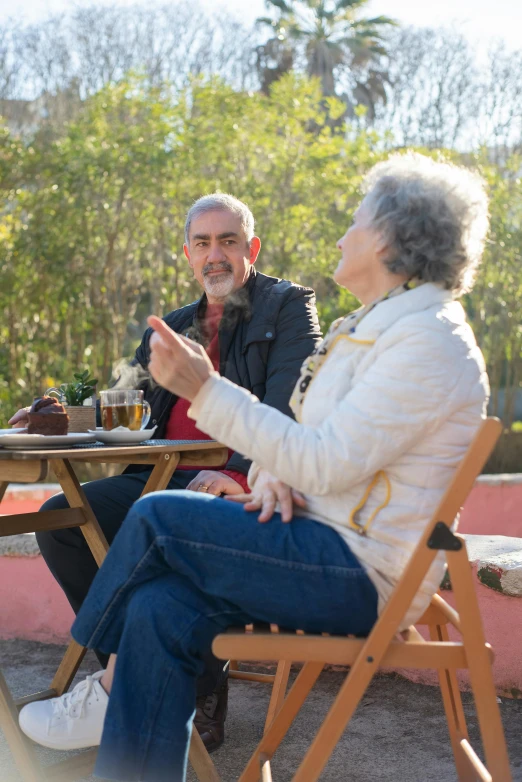 an older couple at a table with a view