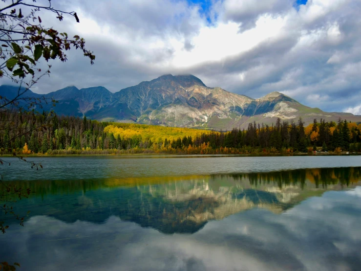 the mountains are reflecting in the calm lake water