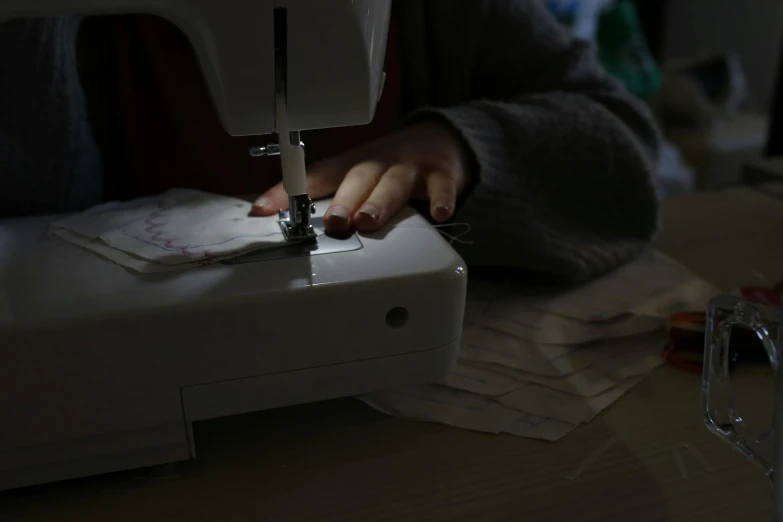 a woman sews and sewing on a sewing machine