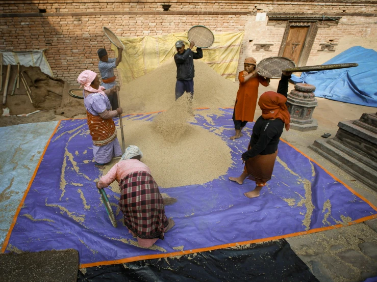 the men are painting soing on the tarp