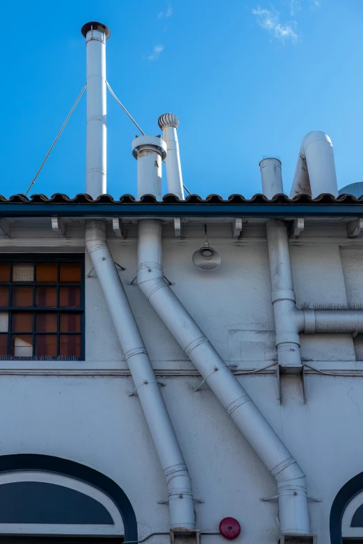 pipes on the side of a building that is not working