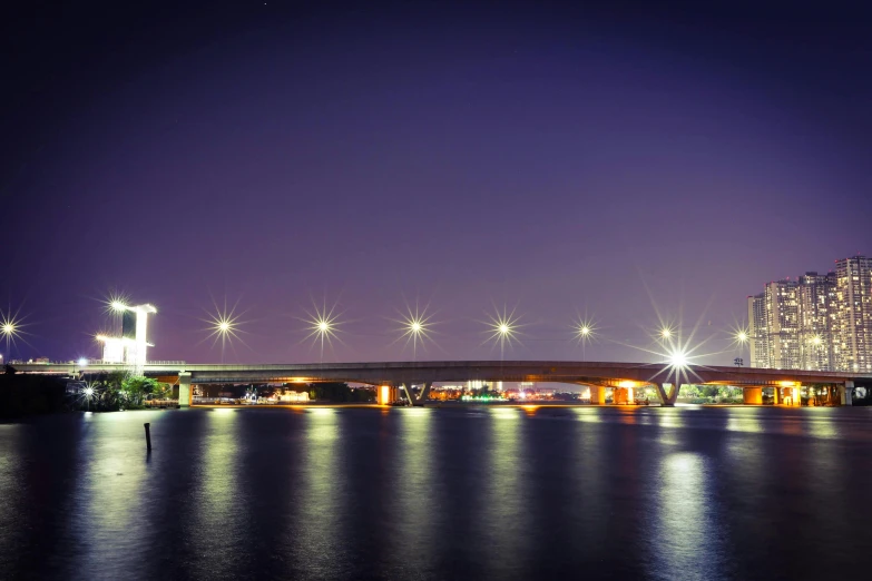 a bridge spans over water near a building and other buildings