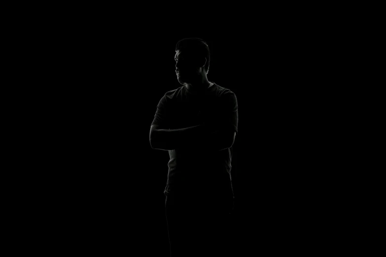 a man that is standing in the dark