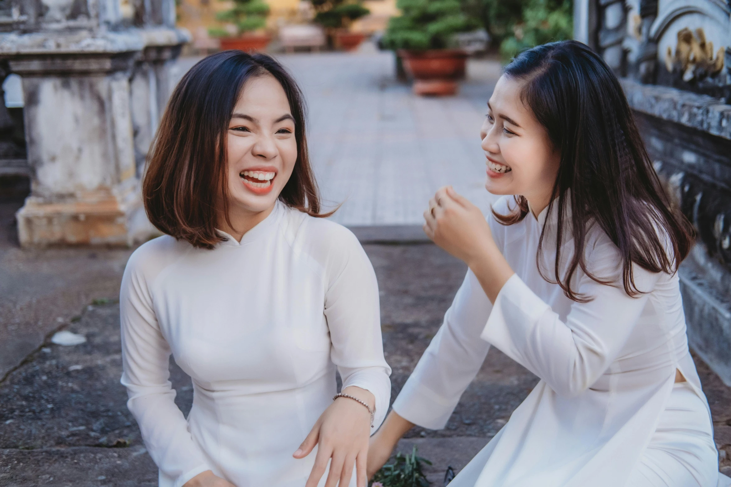 two asian women talking and laughing together