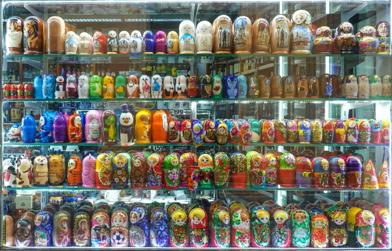 shelves filled with many colorful colored vases