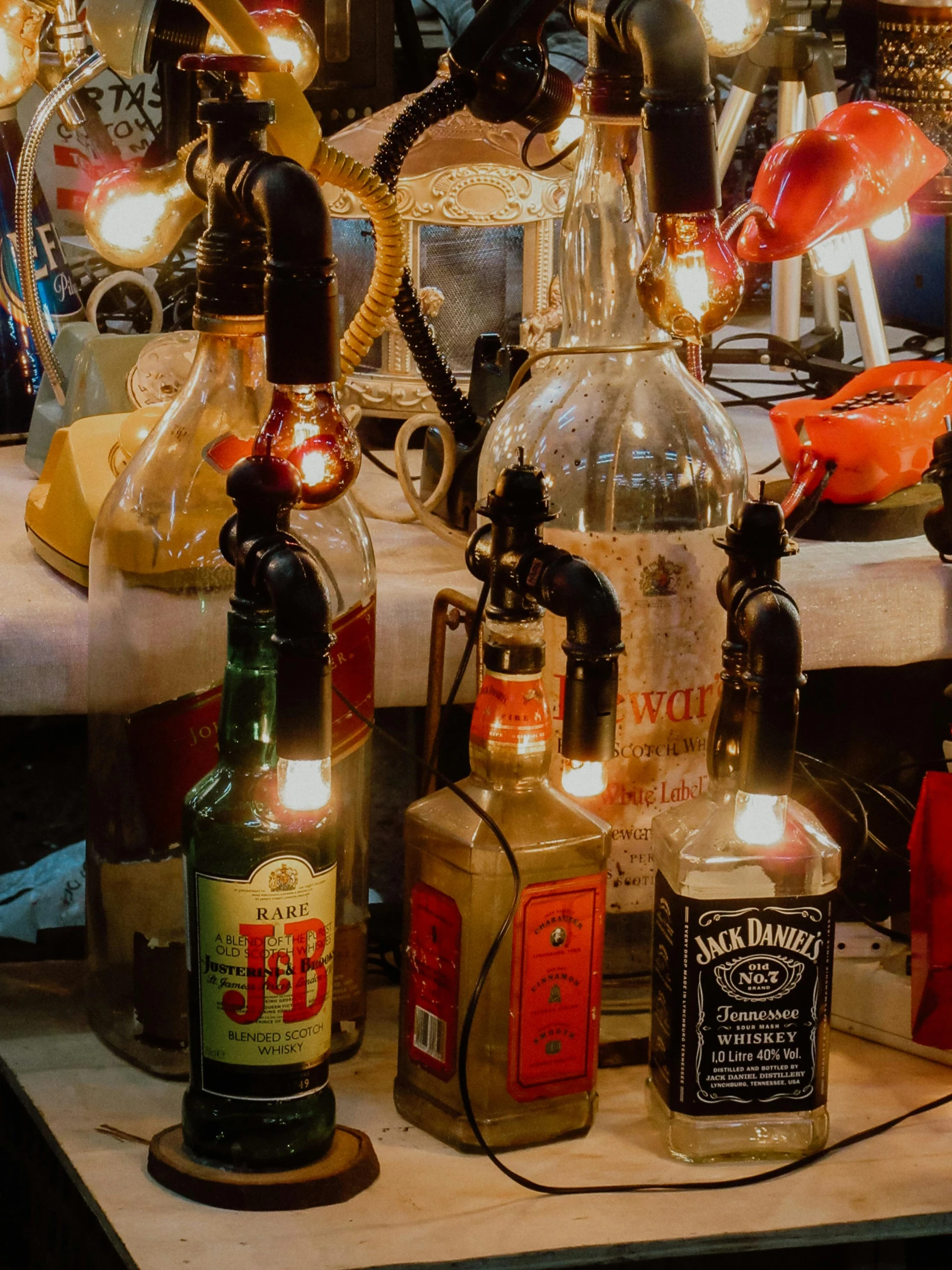 bottles are sitting on a table with small lights