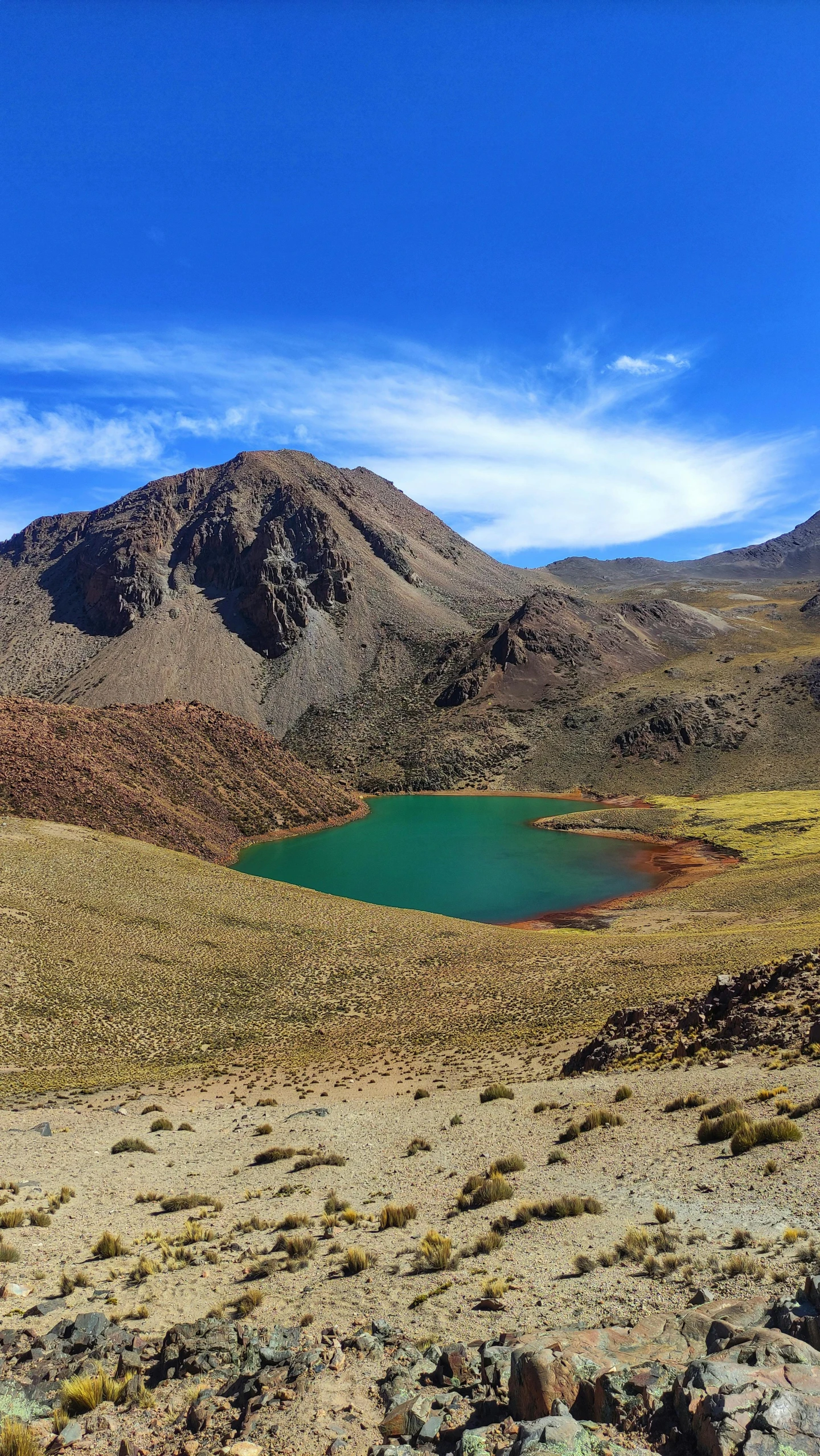 a scenic view of a large mountain range and lake