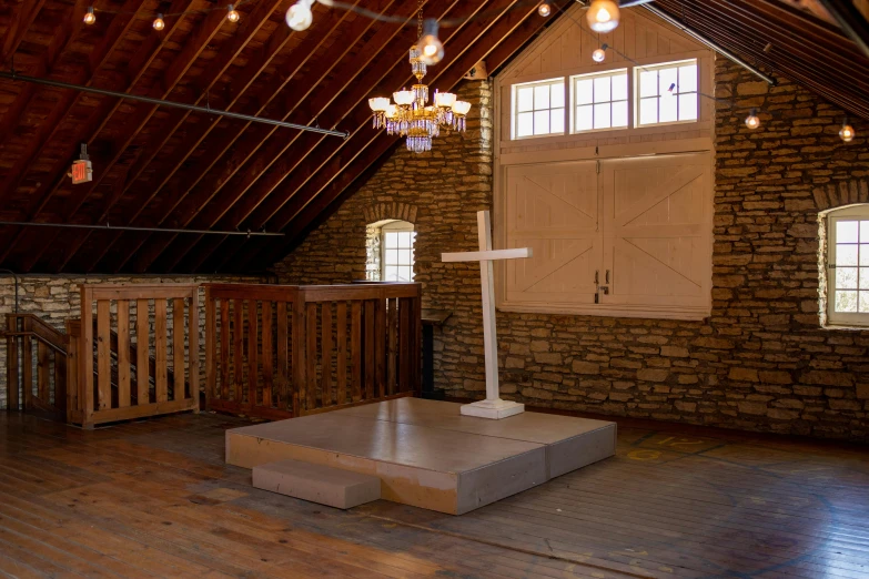 an empty church with wood floor and exposed ceilings