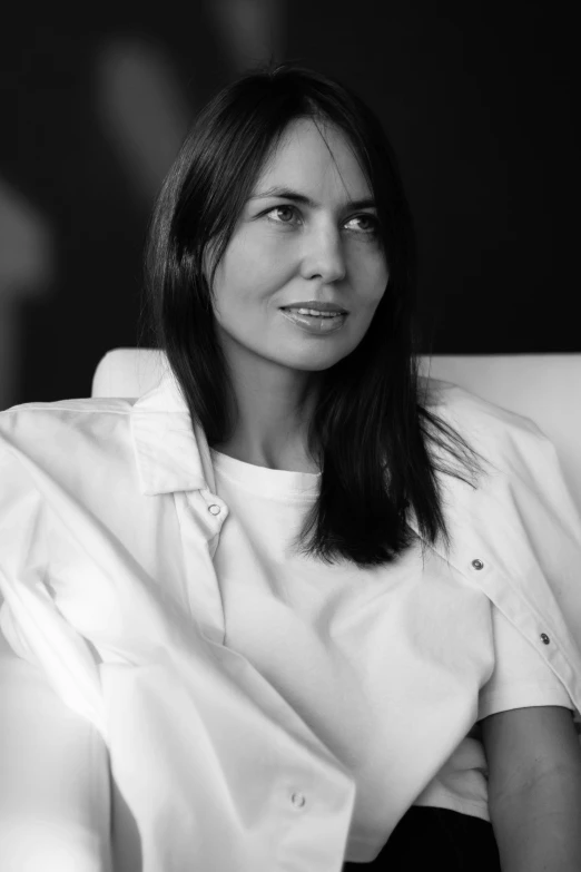 a woman sitting on top of a white couch