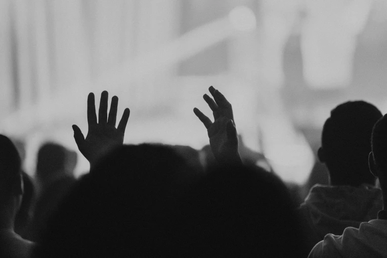 a group of people who are clapping in front of some