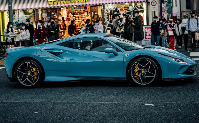 the ferrari laferina sits parked in front of the crowds