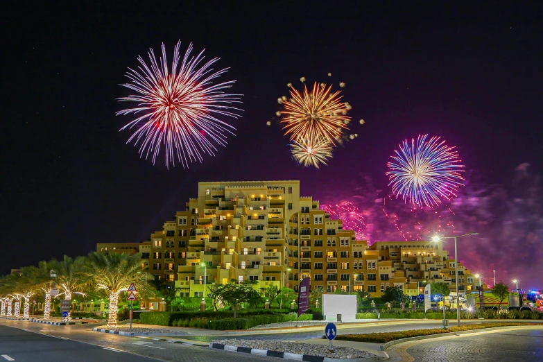 a view of fireworks coming from buildings in the night sky